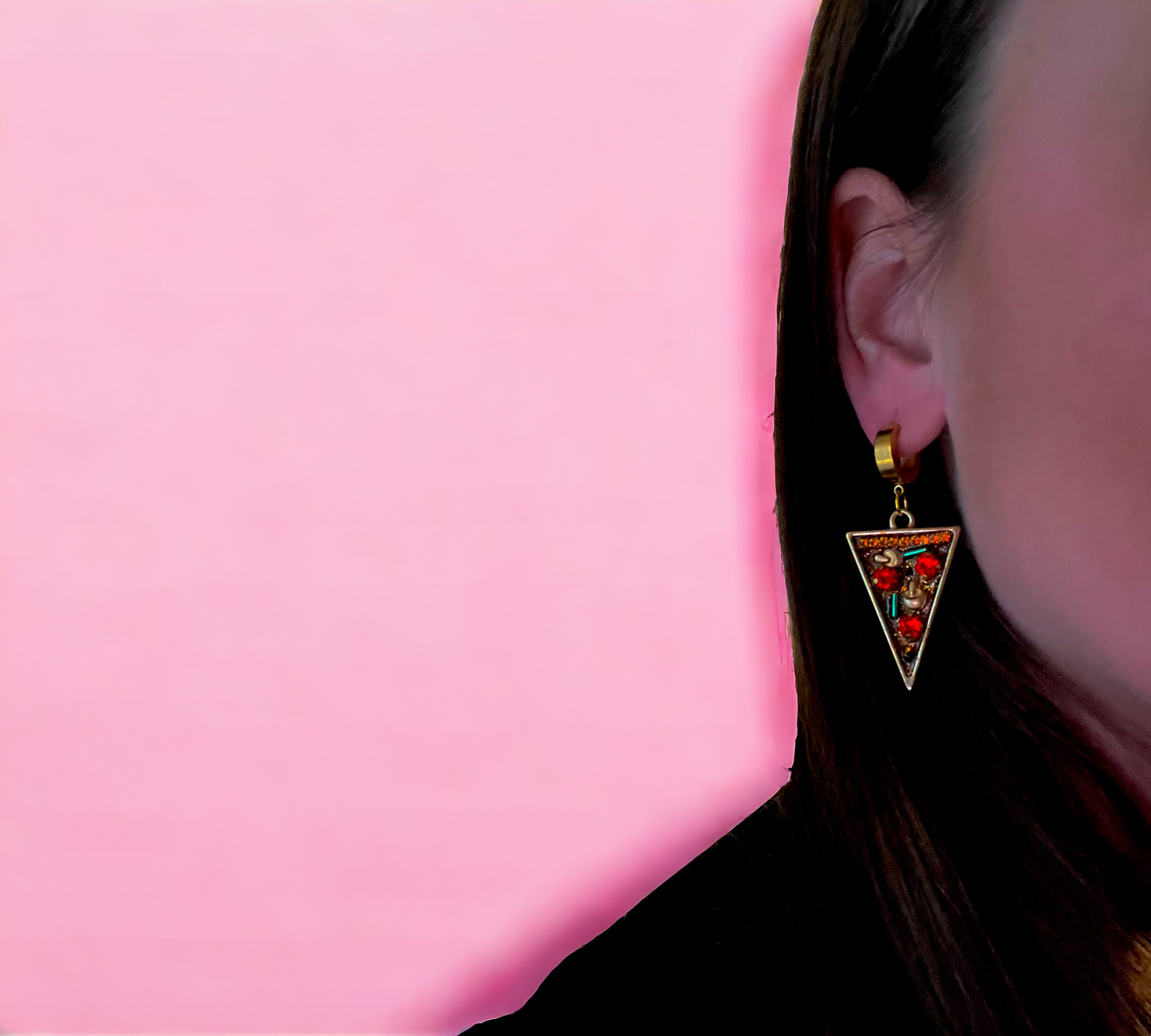 lifestyle photo of pizza party earrings shown on ear of model for scale 